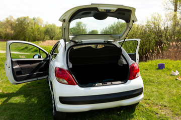 Car with open trunk and doors. white car