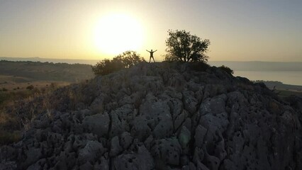 sunrise over the golan heights and lake of galilee in israel. drone flying over a hill in the galilee towards the sunrise. morning views of the sea of galilee from the air. israeli sunrise.