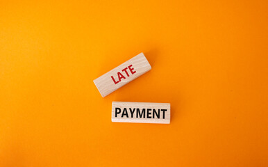 Late payment symbol. Concept word Late payment on wooden blocks. Beautiful orange background. Business and Late payment concept. Copy space