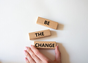 Be the change symbol. Concept word Be the change on wooden blocks. Businessman hand. Beautiful white background. Business and Be the change concept. Copy space