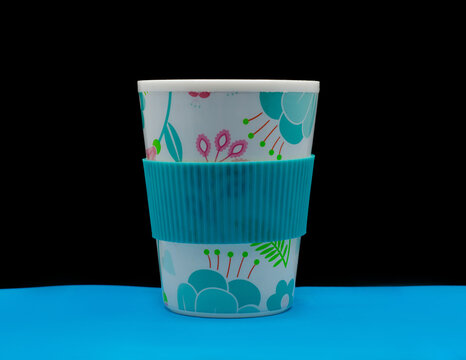 multicolour eco-cup of coffee on black background