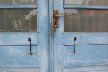 background of vintage  tiaged hook on the blue wooden door design for protection concept