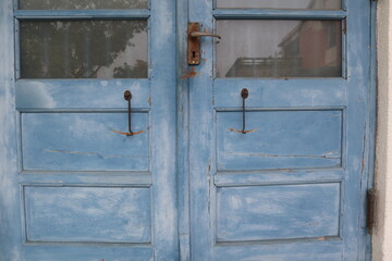 background of vintage  tiaged hook on the blue wooden door design for protection concept