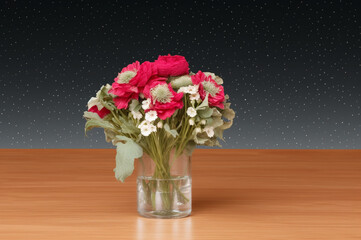 Vase of red flowers on table
