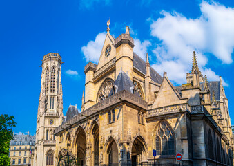 Fototapeta na wymiar Paris beautiful city landscape with tulip flower garden in front of the historic Saint-Germain-l'Auxerrois Gothic style church in France