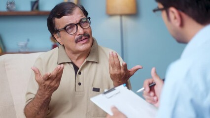Indian senior elderly man with psychologist explaining his problems during counselling at home - concept of mental illness, depression and psychotherapy session - Powered by Adobe