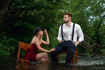 couple in love decide relationship, girl in red dress in water, man at table in water, boy and girl decide relationship