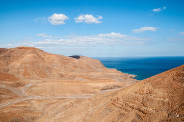 View of a volcanic desert area near the sea in Fuerteventura, Canary Islands.