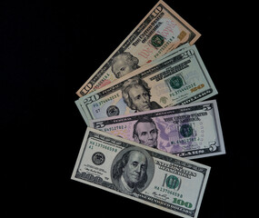 american dollars lie on a black background