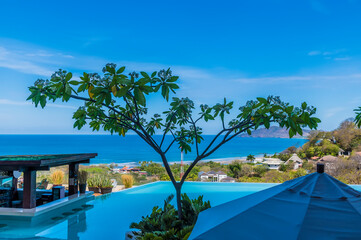 A view past a pool over the resort of Tamarindo in Costa Rica in the dry season
