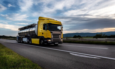 Fototapeta na wymiar Gasoline tanker, Oil trailer, Tank truck on highway close up on a Highway road with a beautiful dramatic sunset sky in the background