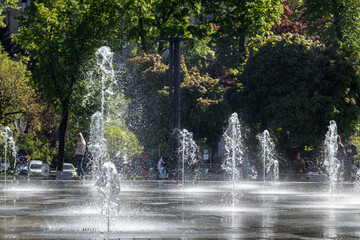 Fountains water drops close-up on Freedom square (Maidan Svobody) in Kharkiv city center. Tourist attraction and recreation area on a spring sunny day