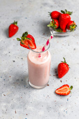 Pink strawberry milkshake in glass jar on rustic background, healthy food for breakfast and snack, strawberry smoothie and scattered strawberry isolated on white, strawberries milkshake, milk shake.