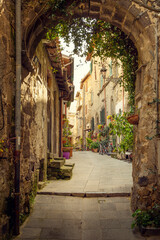 Fototapeta na wymiar Narrow street in Marta town, Tuscany, Italy