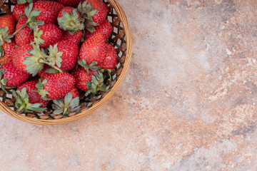 Bowl of strawberries, Fresh strawberries in plate on table, Heap of fresh strawberries in ceramic bowl, Top view fresh strawberry in wrought plate on concrete board, Fresh juicy strawberry.