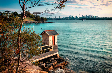 The view of the Camp Cove Jetty in the Watsons Bay with Sydney CBD in distance in sunny days.