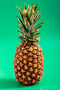 Isolated pineapple on green background