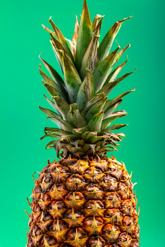 Isolated pineapple on green background