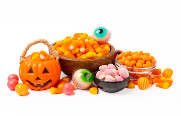 Halloween corn, jelly eyes, sugar skull and pumpkin candy isolated on white background. Classic sweet treats for Halloween. Halloween holiday concept with corn and jack o lantern.