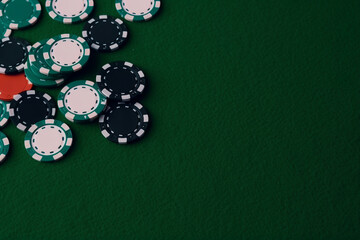 top view of stacks of casino poker chips on the green carpet table