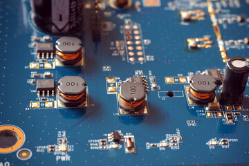 Êlectronic components on a motherboard. Coils, resistors and chips on the Printed Circuit Board. 