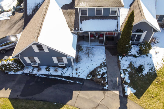 aerial view of house with snow on the roof in winter