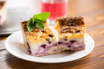 cooked cottage cheese casserole with berry filling in a plate