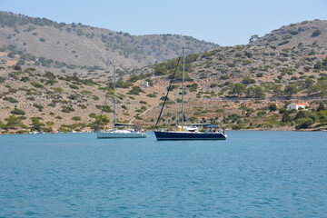 A boat in a bay with a blue sea and mountains on background 