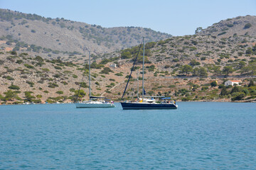 A boat in a bay with a blue sea and mountains on background 