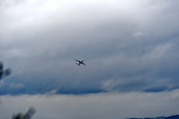 Fototapeta na wymiar Swiss intercontinental airplane taking off from Swiss airport at City of Zürich on a cloudy and rainy spring day. Photo taken April 28th, 2023, Zurich, Switzerland.