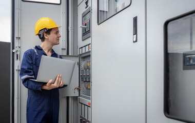 Electrical engineer working in control room. Electrical engineer man checking Power Distribution...