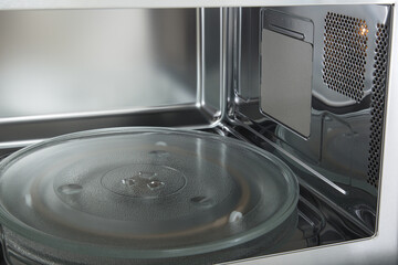 opened microwave inside oven close-up 