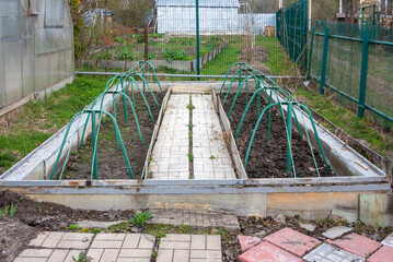 Open low greenhouse in the garden for growing plants.