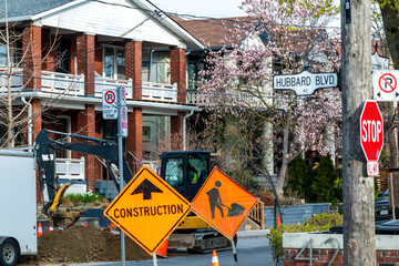 construction signage on a residential street in an established neighbourhood in spring with a...