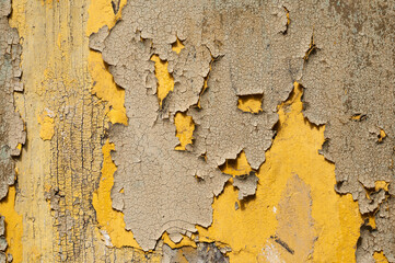 Yellow wood background / Background from a wooden plank with weathered yellow paint. - 597522467