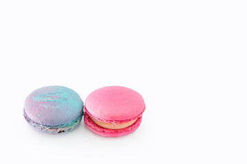 Sweet colorful macarons isolated on white background. Tasty colourful macaroons. Two multi-colored blue and pink macaroons. French pastry made from egg whites.