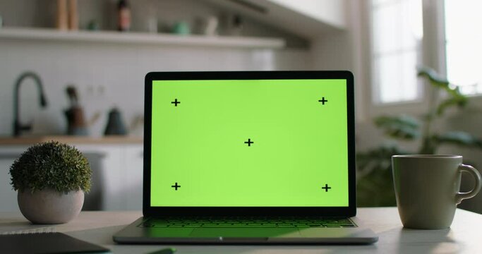 Camera zooms out from laptop mockup with green screen. Perfect place for morning study from home remotely. Laptop mockup with green screen, tracking markers. Mockup laptop set up for study at morning 