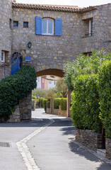 typical street of Port Grimaud with houses and plants in France in spring