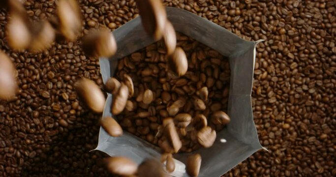 Natural roasted coffee beans fall pour in package for storage, transportation