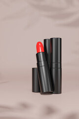 Obraz premium The red lipstick is placed on a pink background for advertisement. 3d rendering.