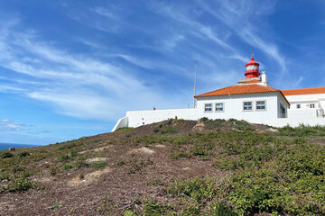 Fototapeta na wymiar Beautiful old lighthouse against blue sky, Cape Da Roca, Cabo da Roca, Portugal
