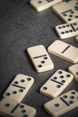 several tiles of classic dominoes on a dark background