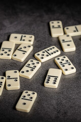 several tiles of classic dominoes on a dark background