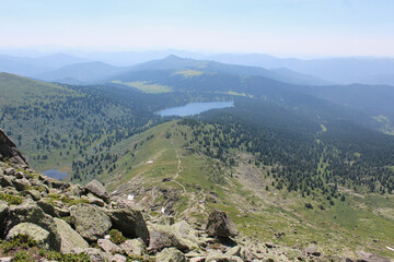 Fototapeta na wymiar View from a high mountain on a hiking trail to lake svetloye in Ergaki nature park