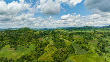 Naklejka na ściany i meble Aerial drone of mountain valley with farmland. Negros, Philippines