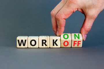 Work on or off symbol. Businessman turns wooden cubes and changes word Work off to Work on....