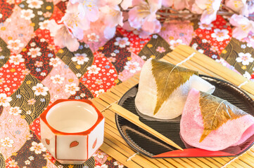 Traditional Japanese wagashi confections called sakuramochi, a sweet pink-colored rice cake with a...