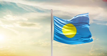 Palau national flag waving in beautiful sky. The symbol of the state on wavy silk fabric.