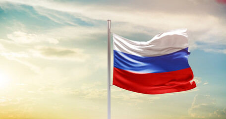 Russia national flag waving in beautiful sky. The symbol of the state on wavy silk fabric.