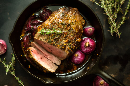 Roast beef with caramelized in wine red onions in cast iron skillet. Traditional American cuisine dish specialty for family dinner holiday celebrations